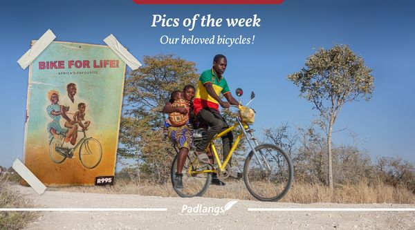Cyclist in Namibia, 2 passengers on bicycle carrier