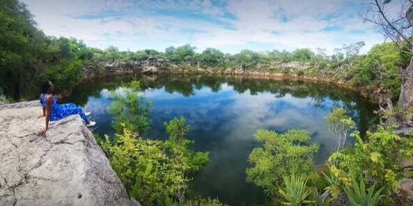 Woman sitting at Lake Otjikoto