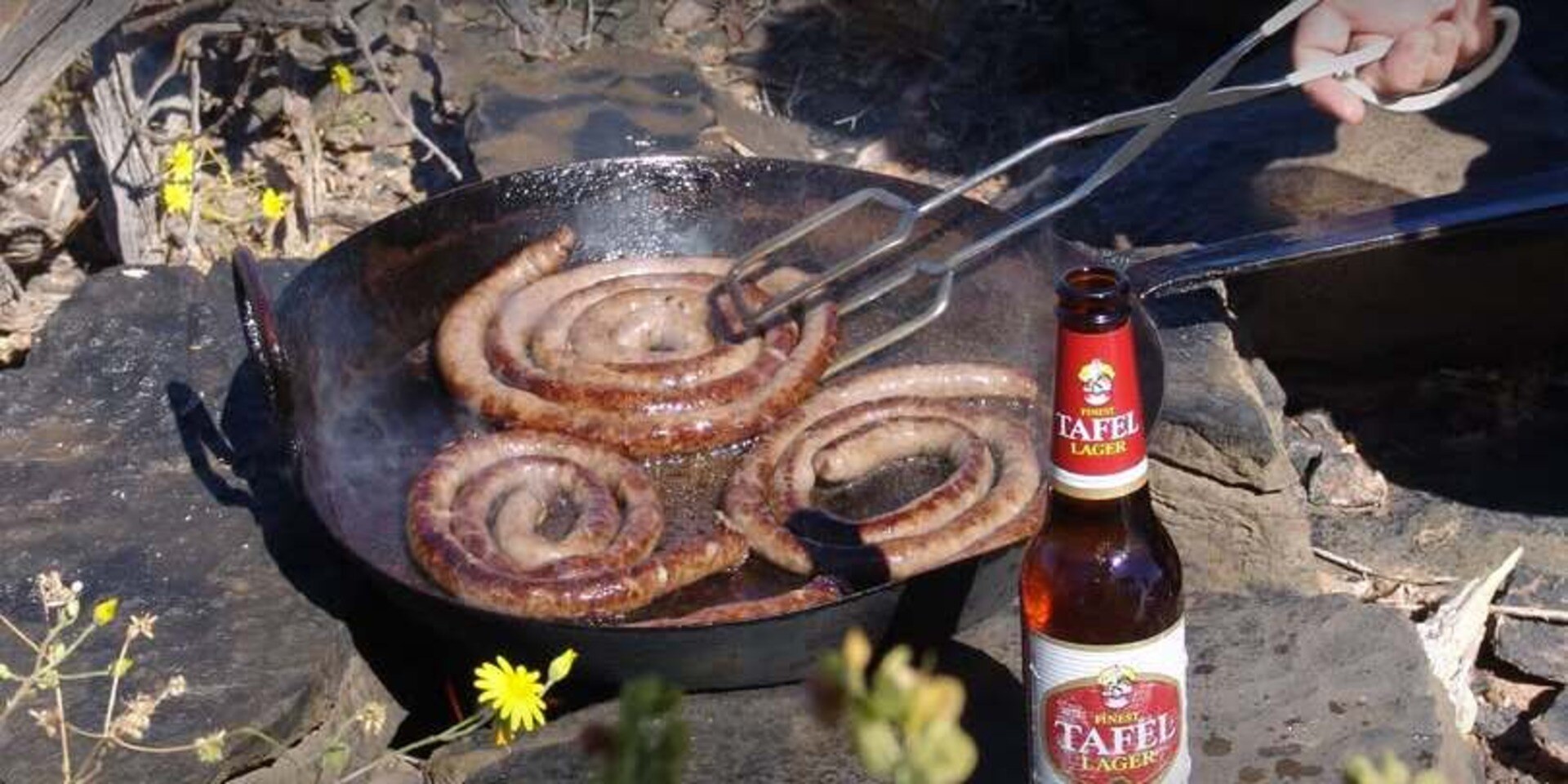 Braaing boerewors on a braai stove