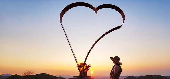 Woman next to fire heart