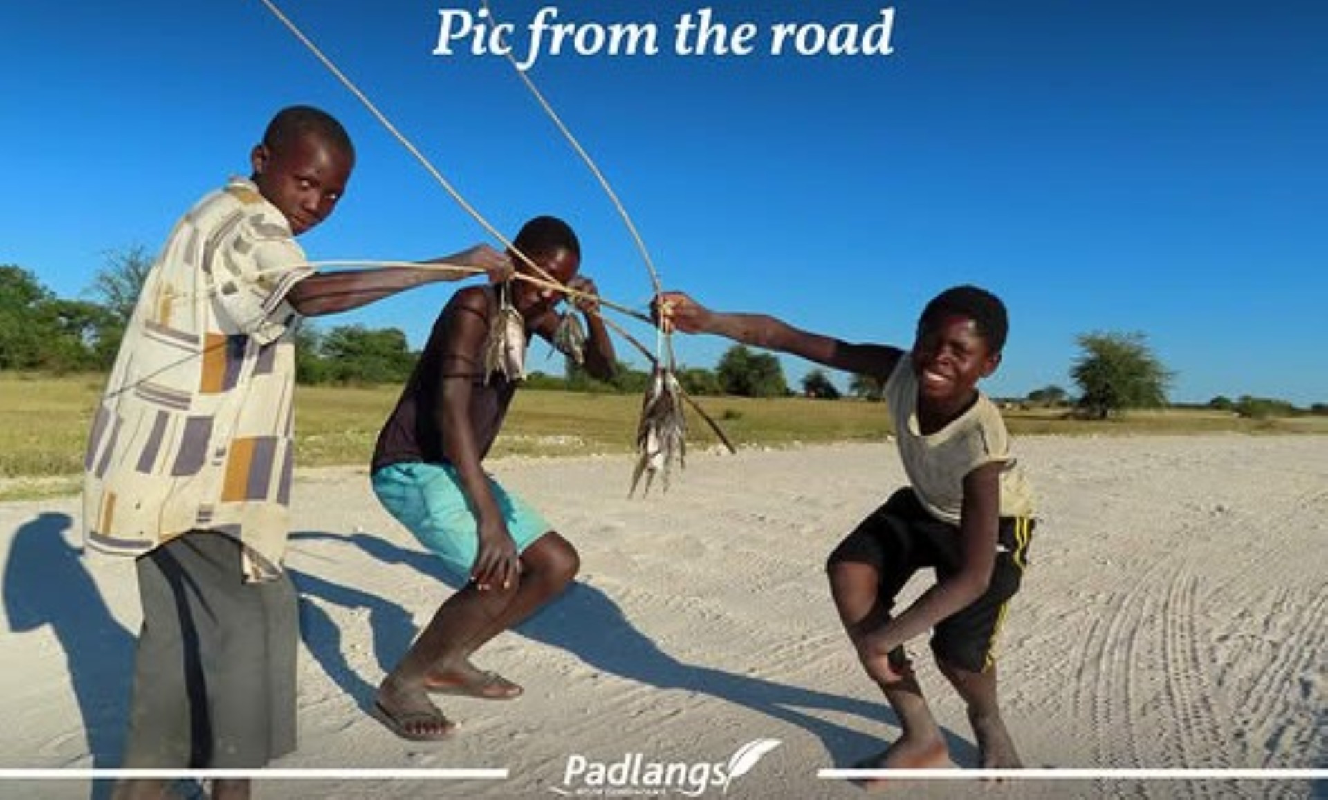 Along the Okavango River, young fishermen proudly show their catch