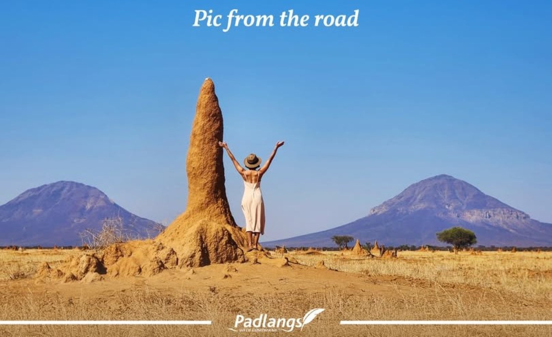 Tall termite mound in the foreground with the Omatako Mountains rising behind it, photographed along the road between Windhoek and Otjiwarongo.